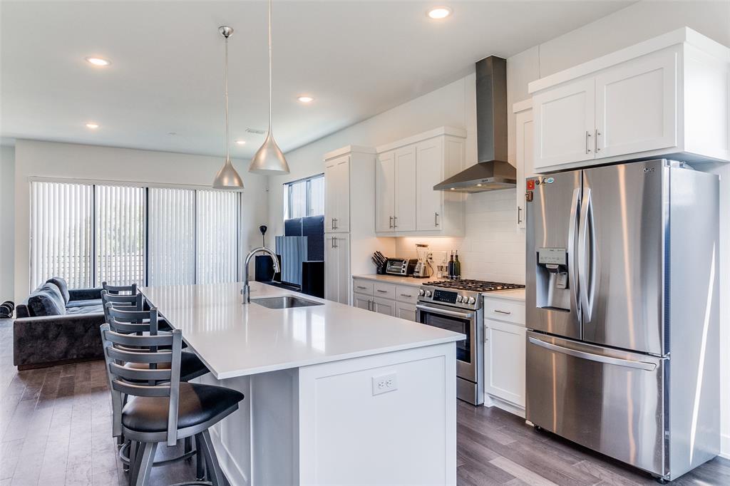 a kitchen with kitchen island a counter and a refrigerator