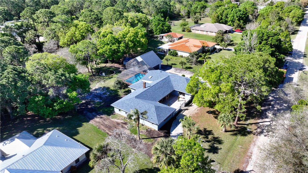 an aerial view of a house with a yard