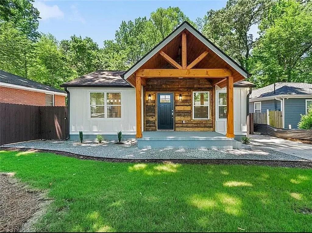 a front view of a house with a yard and porch