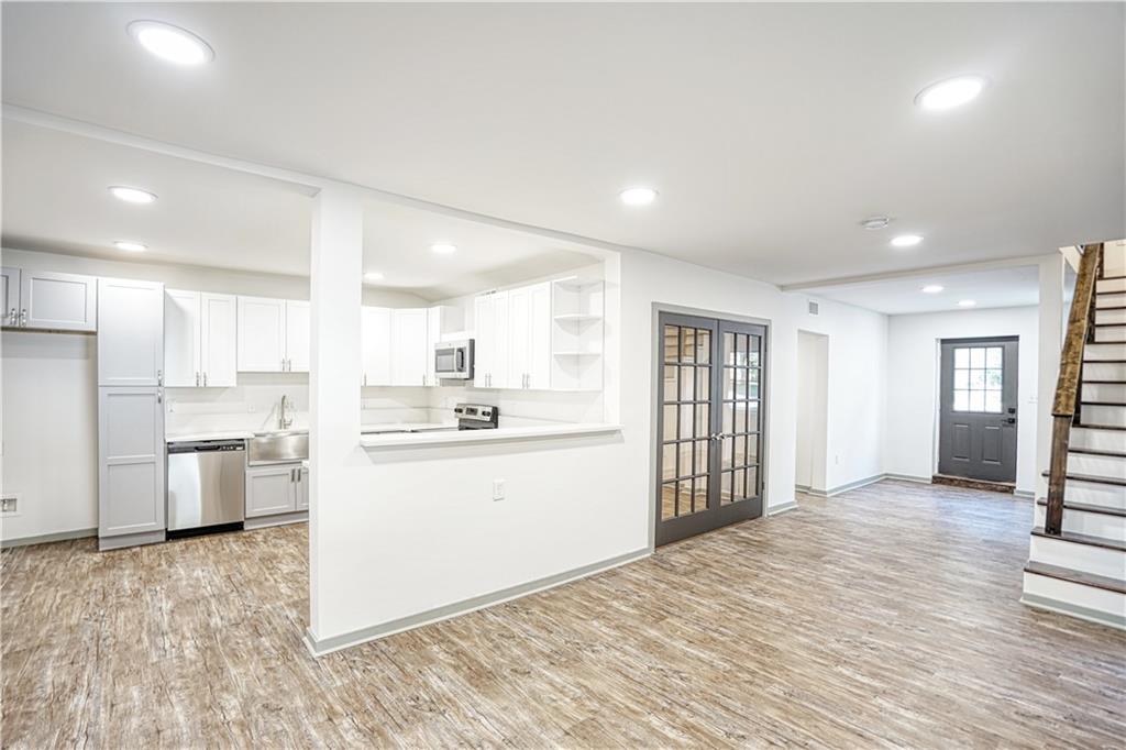 a kitchen with refrigerator and cabinets