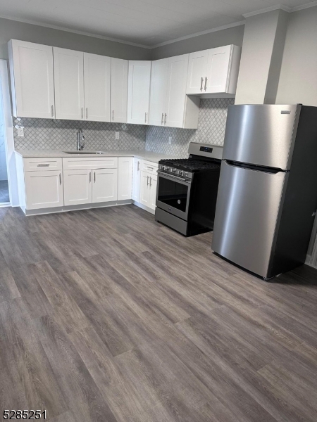 a kitchen with stainless steel appliances granite countertop a refrigerator sink and cabinets