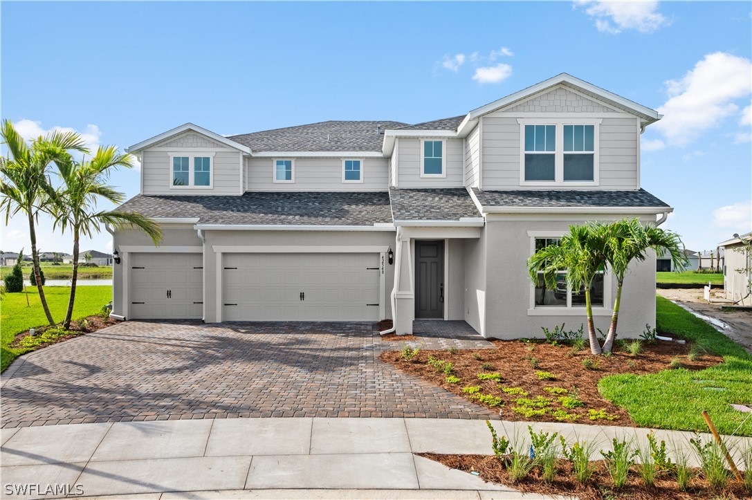 a front view of a house with a yard and garage