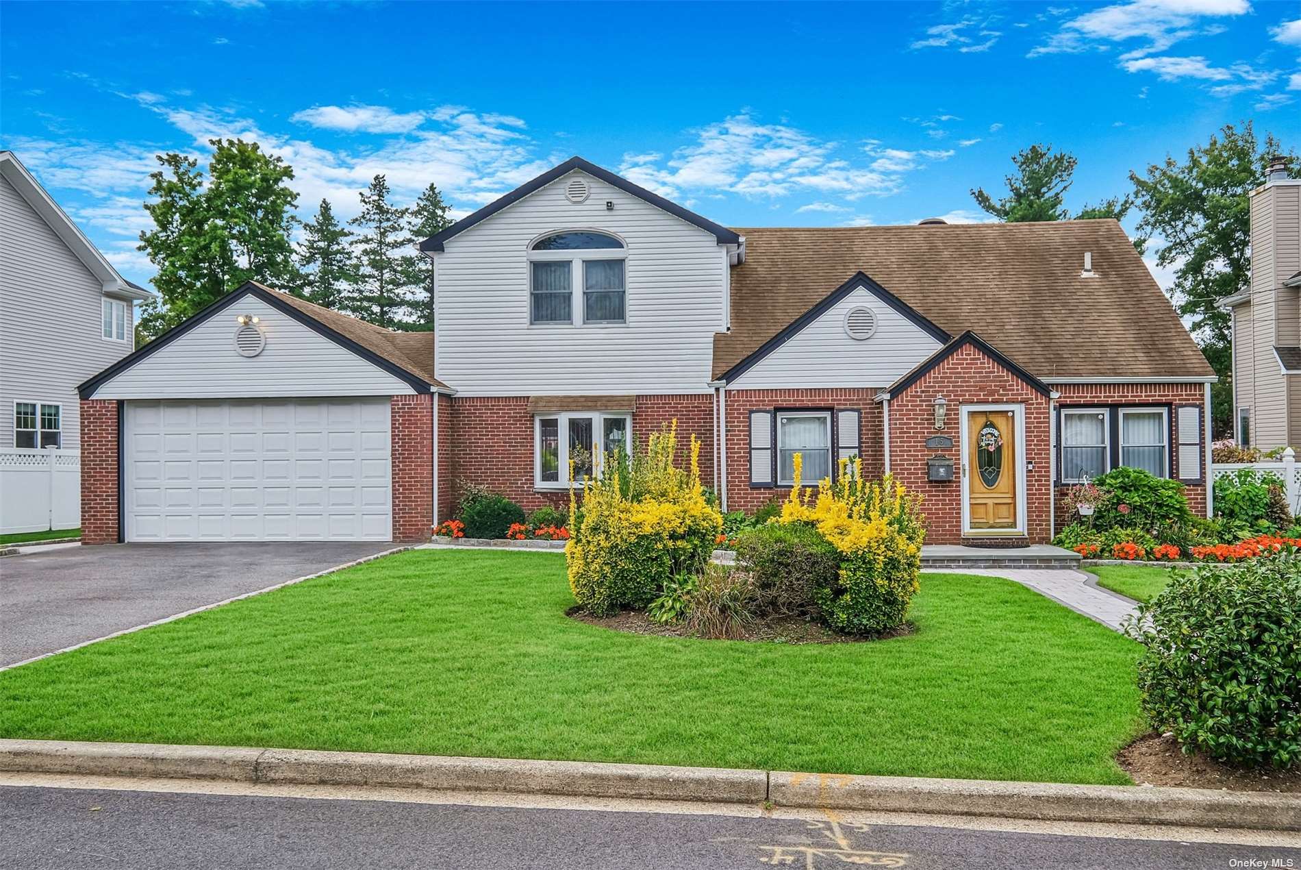 a front view of a house with a garden