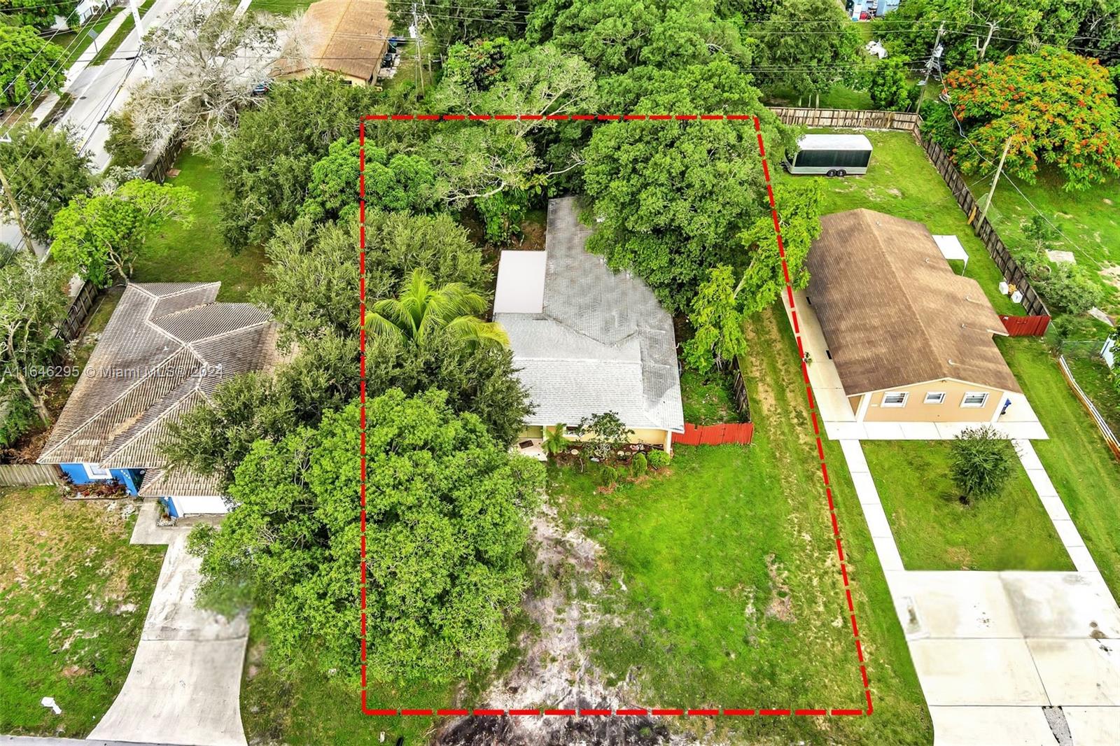 an aerial view of a residential houses with yard