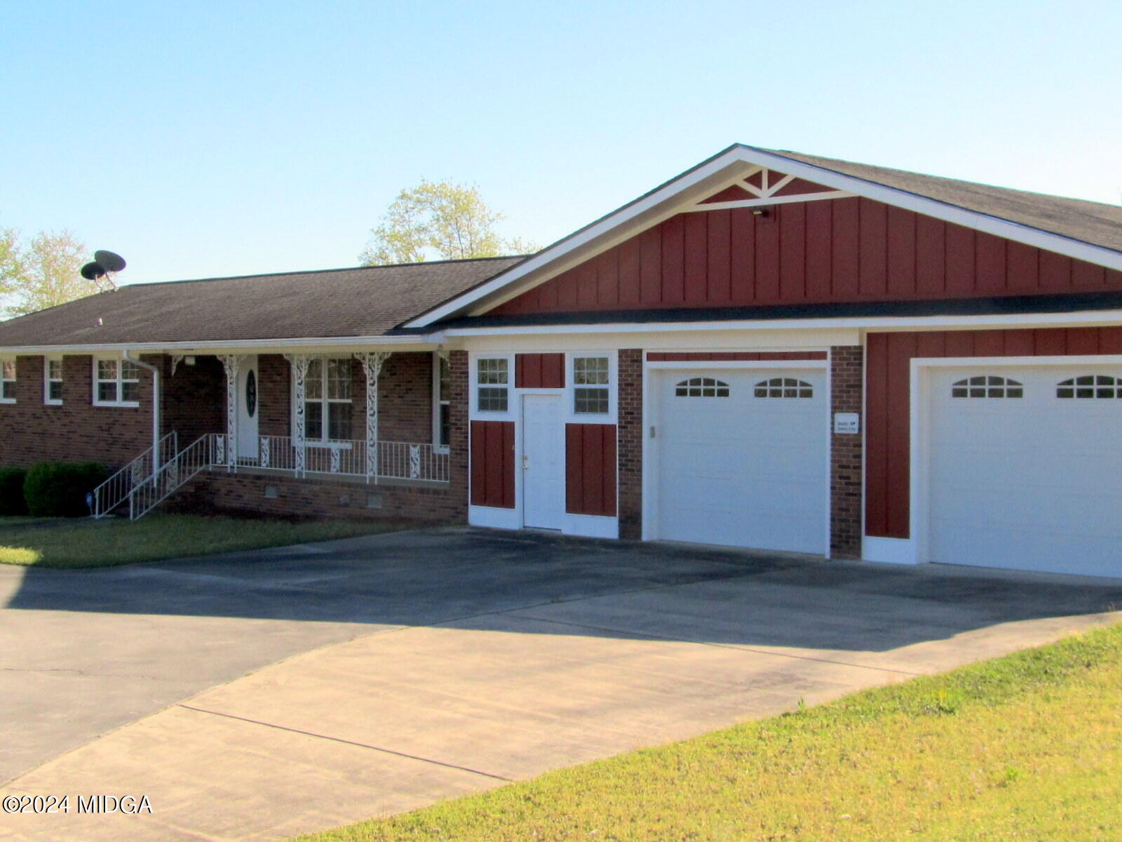 a front view of a house with a garden