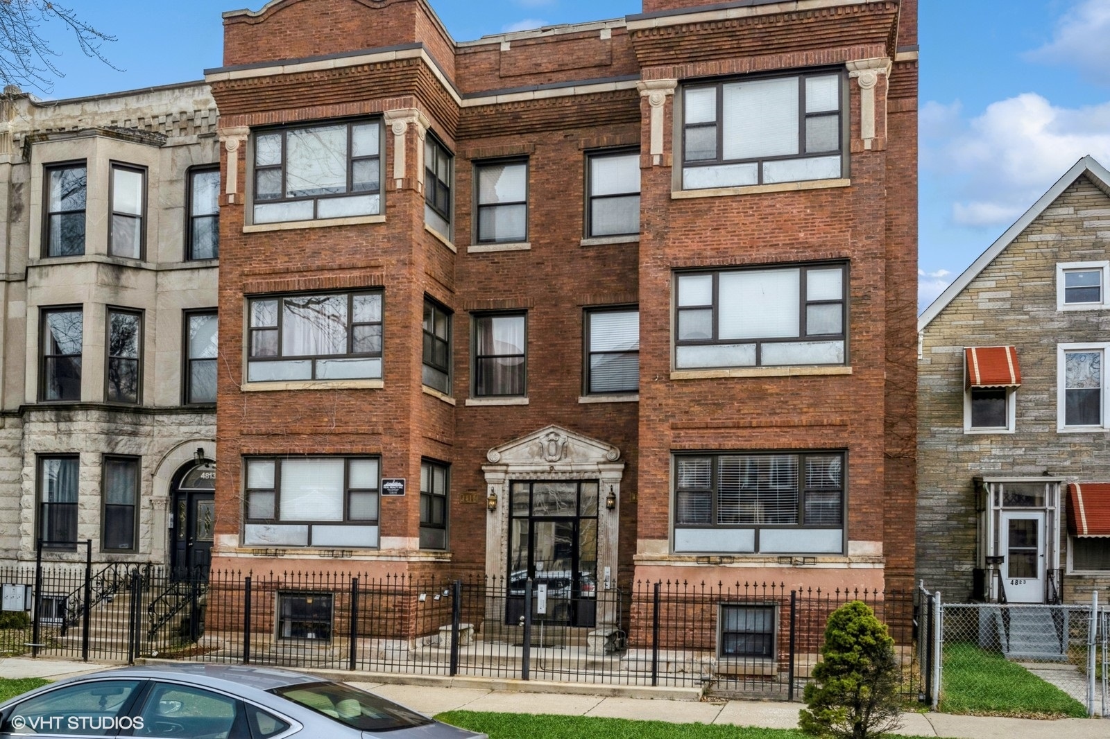 a front view of a residential apartment building with a yard