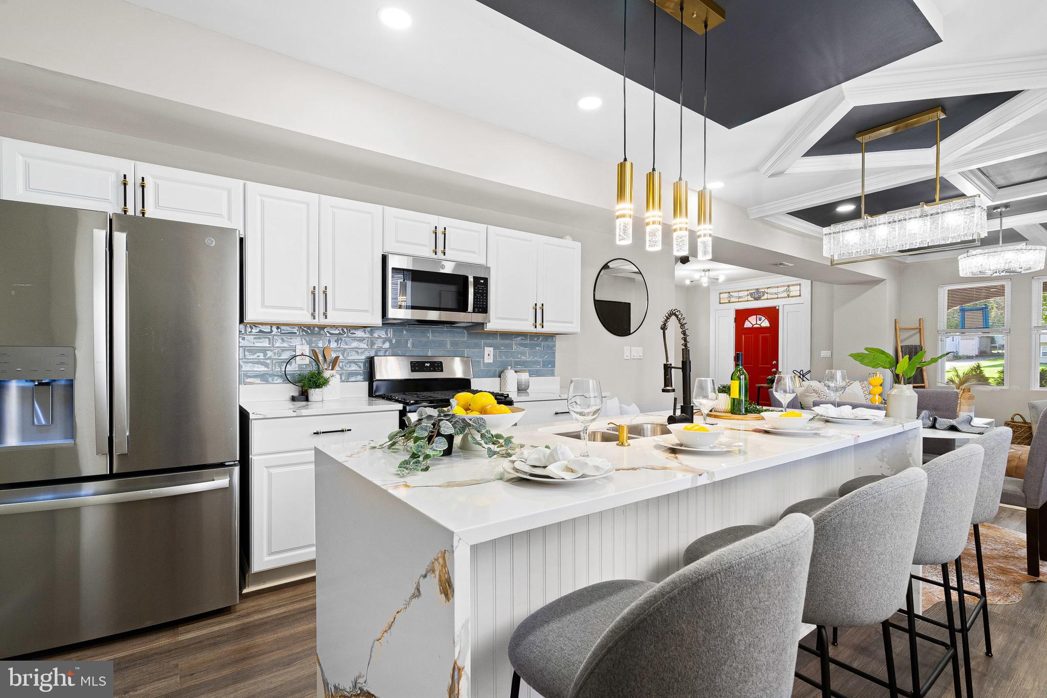 a kitchen with a sink stainless steel appliances and white cabinets