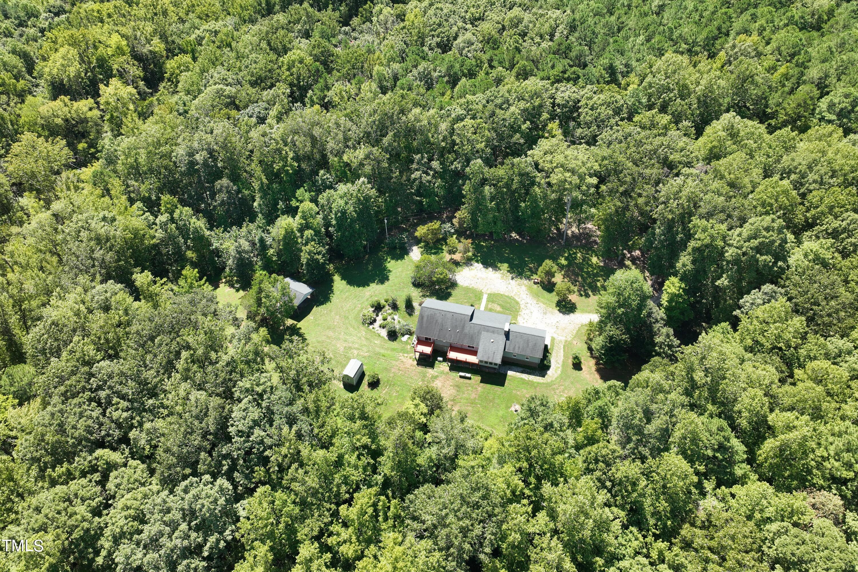 an aerial view of a house with yard and outdoor seating