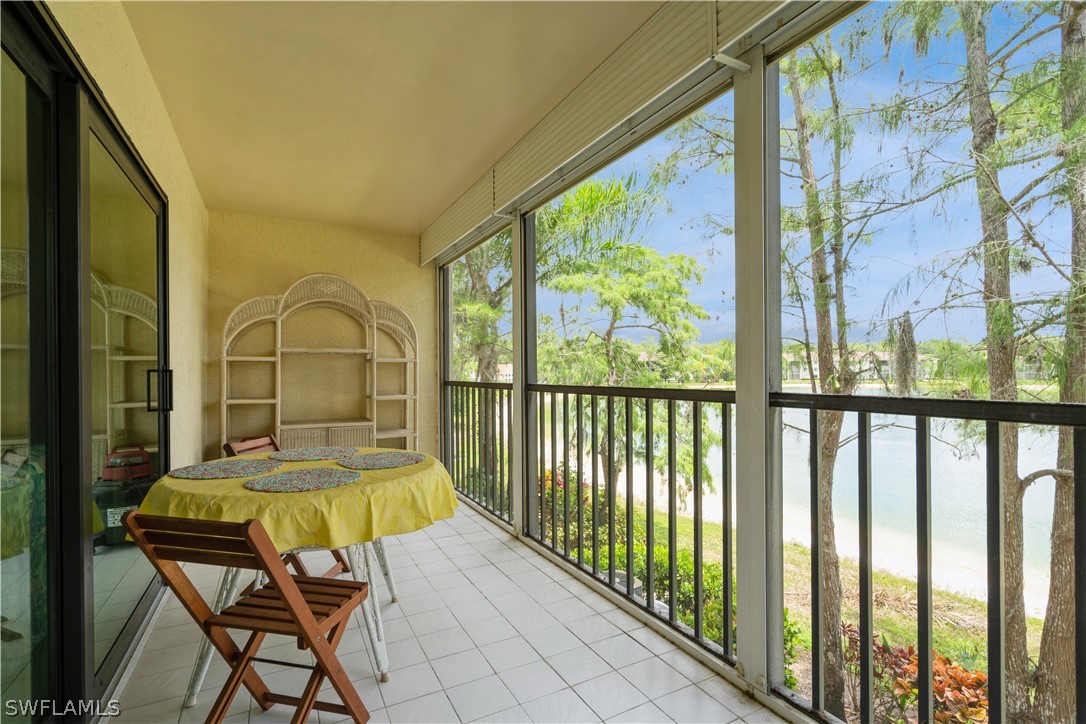 a view of a balcony with chair and floor to ceiling window