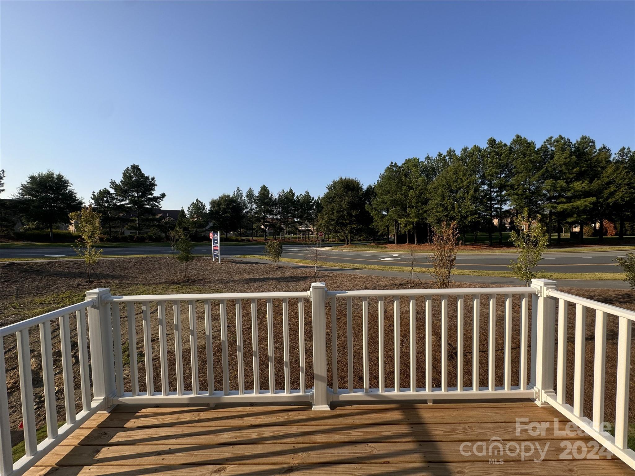 a view of deck with wooden fence and trees