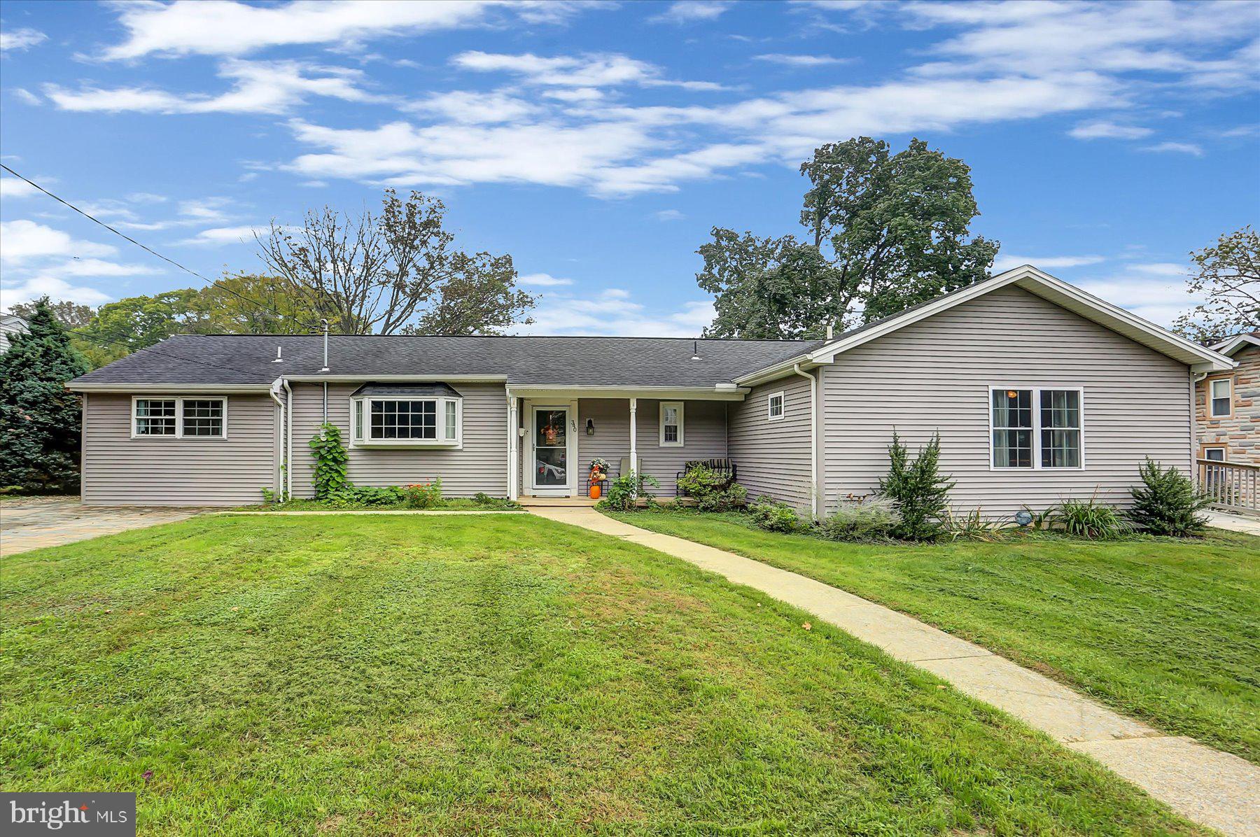 a front view of house with yard and green space