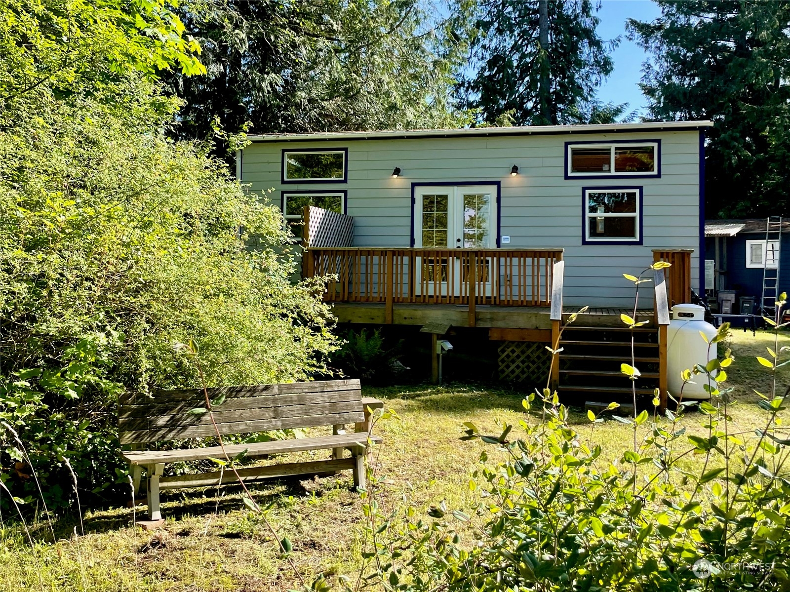 a wooden bench sitting in front of a house