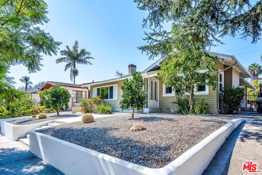 a view of a house with a yard and tree s