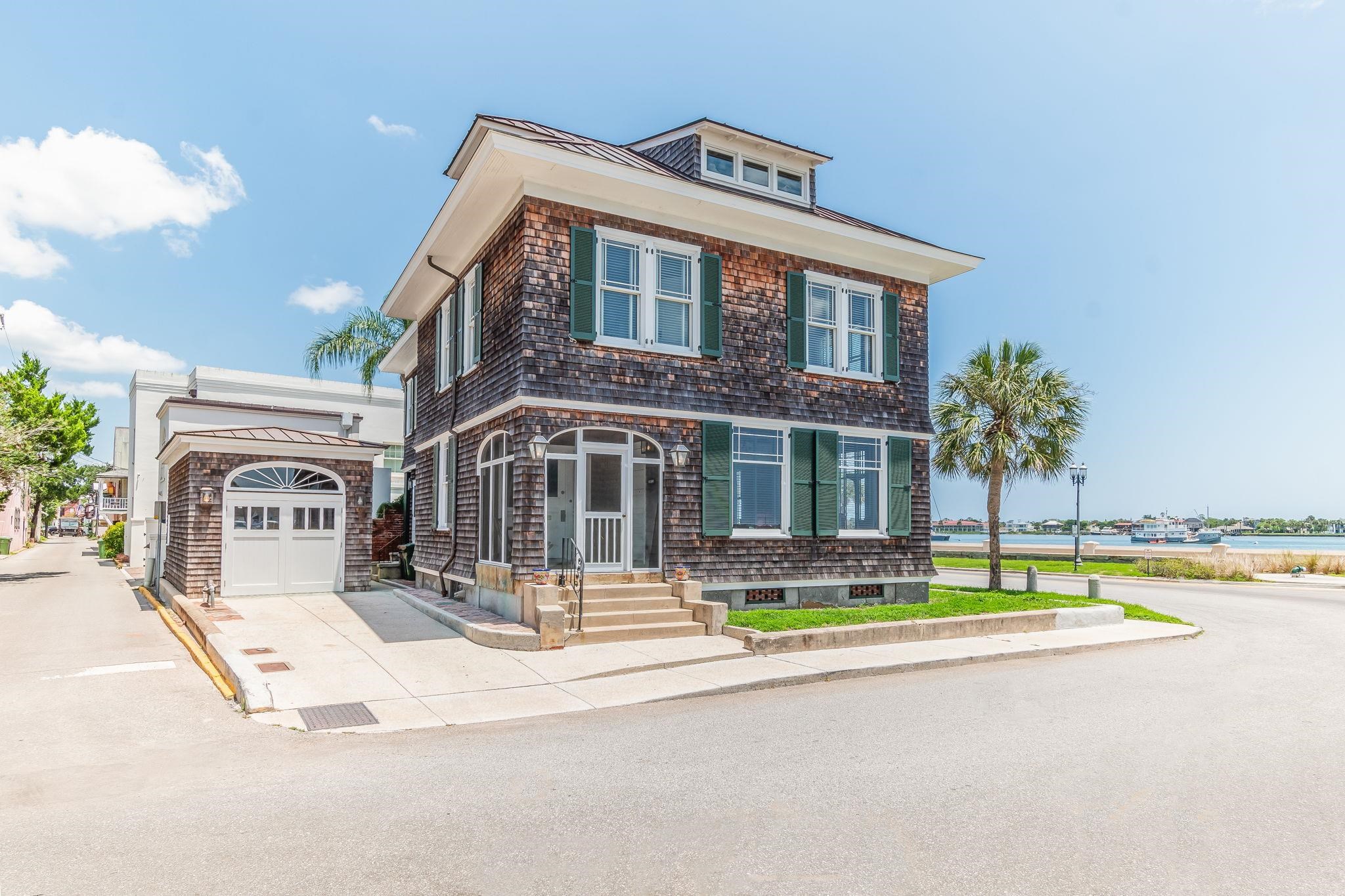 a front view of residential houses with yard and swimming pool