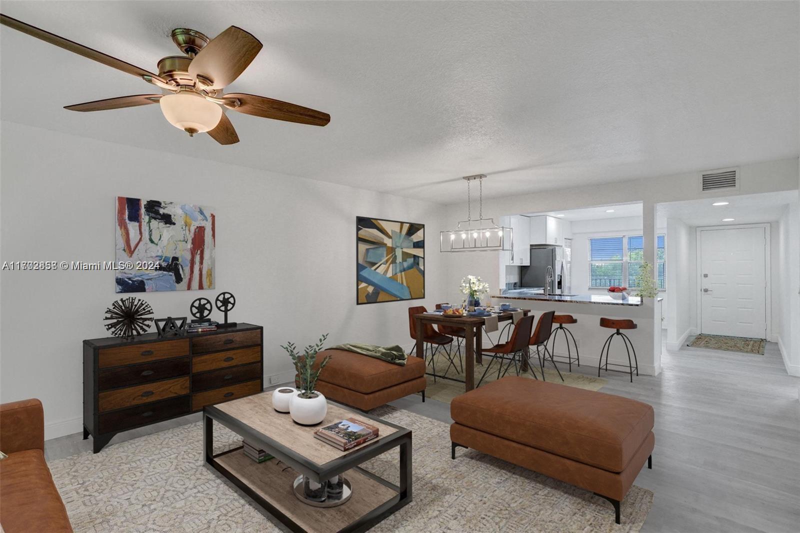 a living room with furniture and a dining table