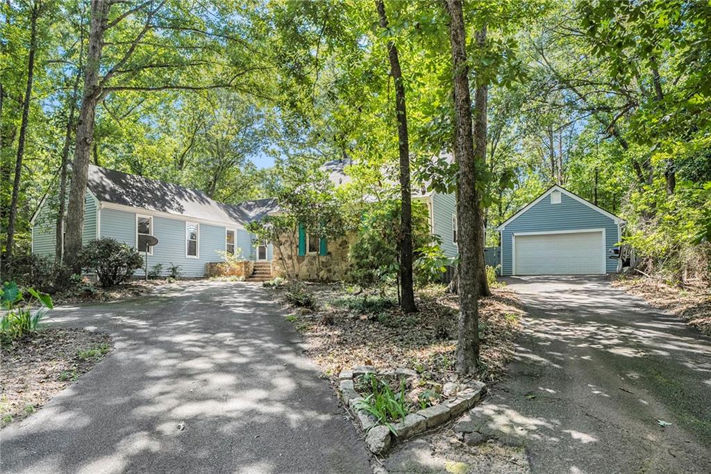 a view of a house with a tree in the background