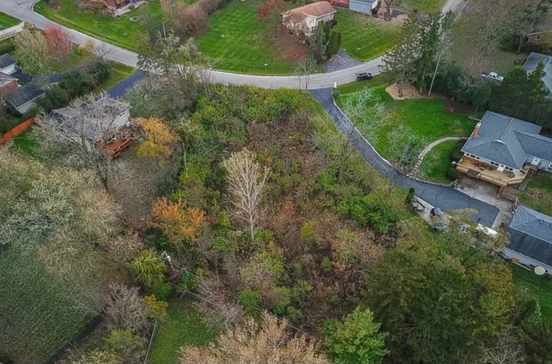 an aerial view of a house with a yard and outdoor seating