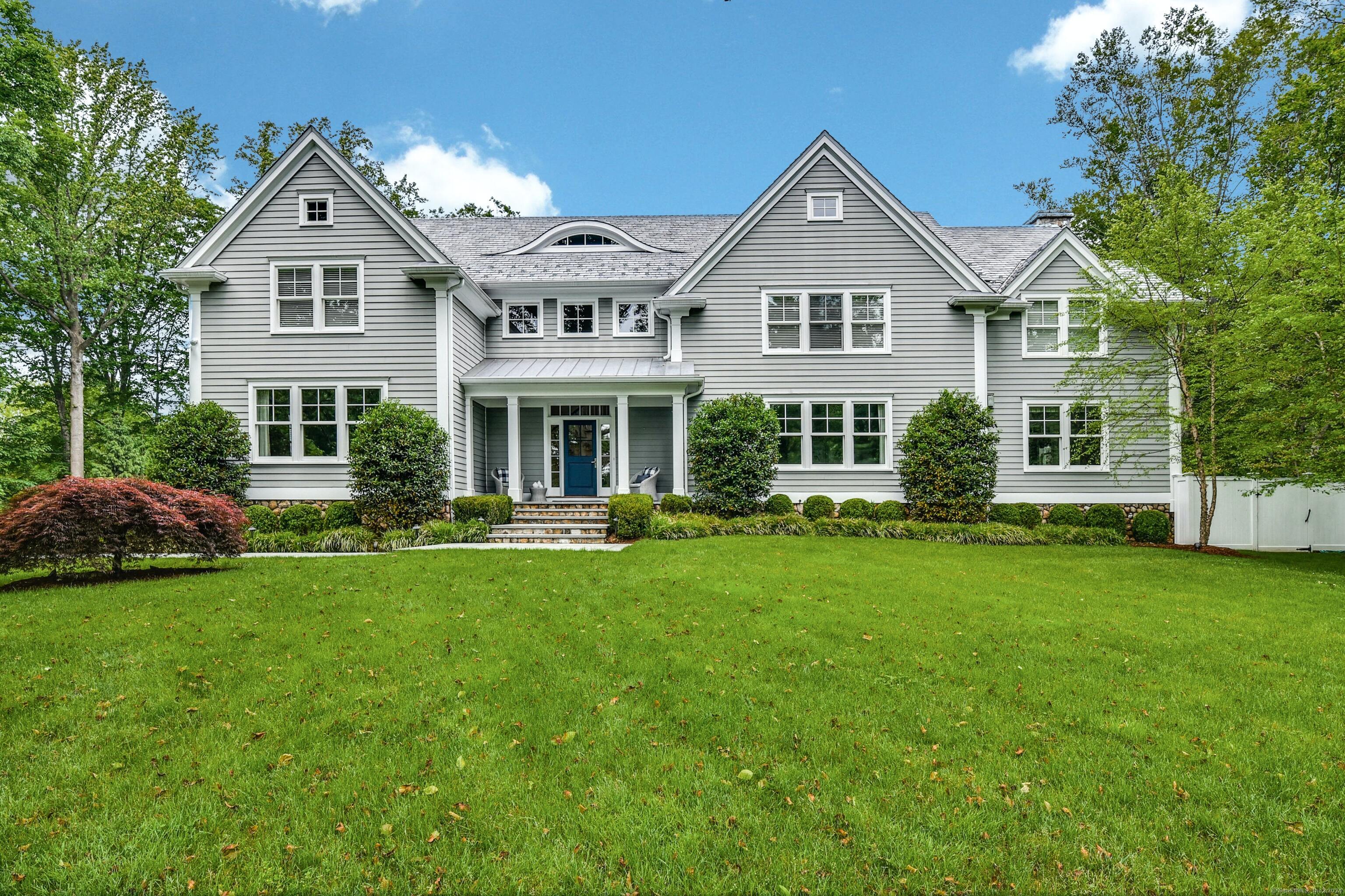 a front view of a house with a garden and porch