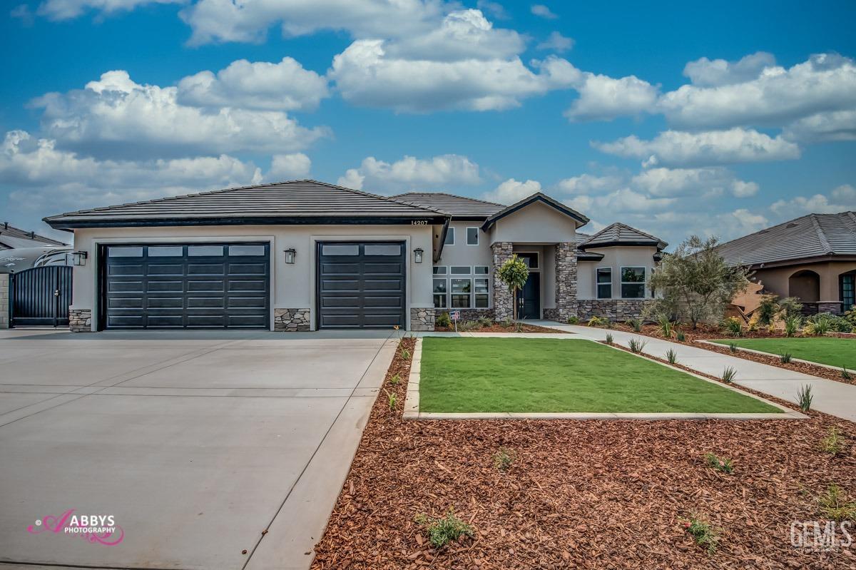 a front view of a house with a yard and garage