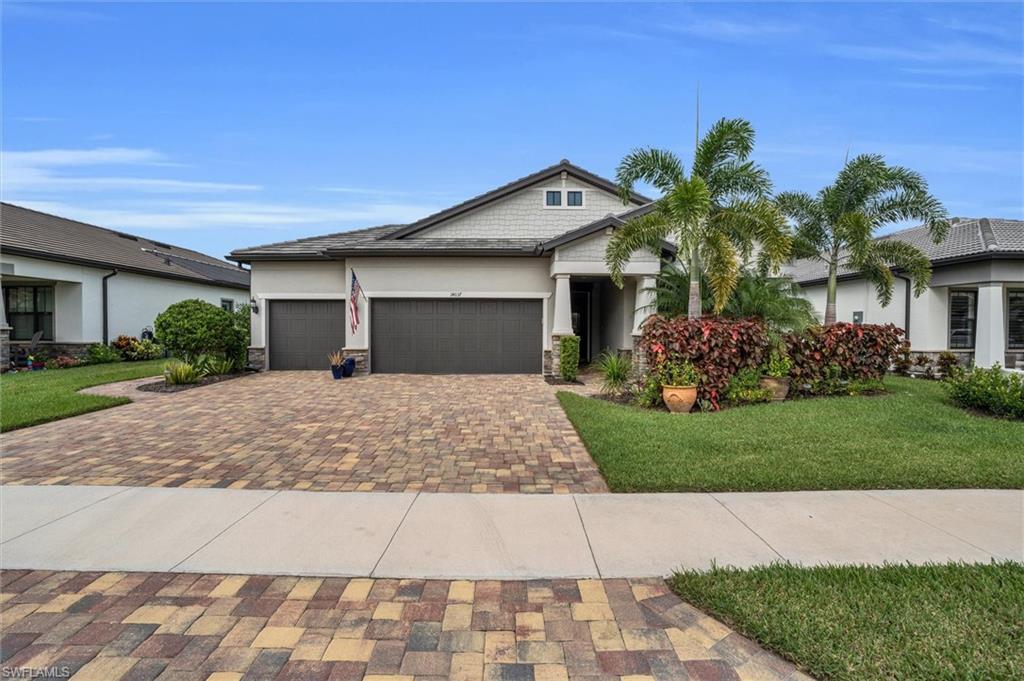 View of front of property featuring a garage and a front yard