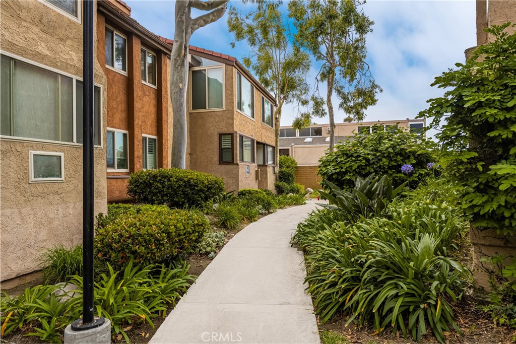 a view of a multi story white building next to a yard