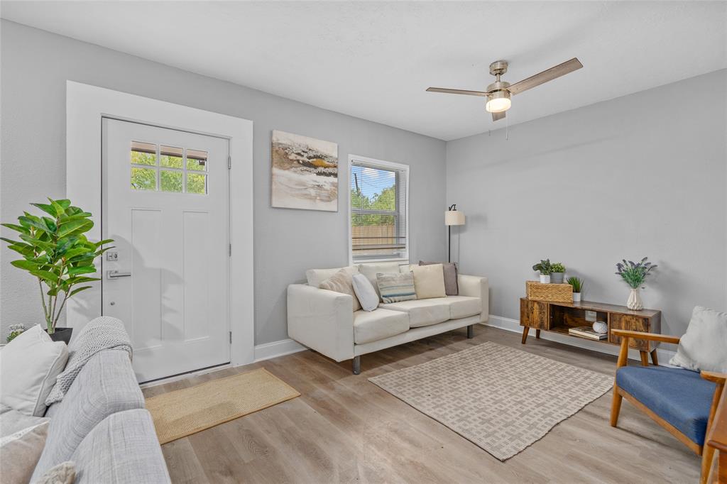 a living room with furniture and a potted plant