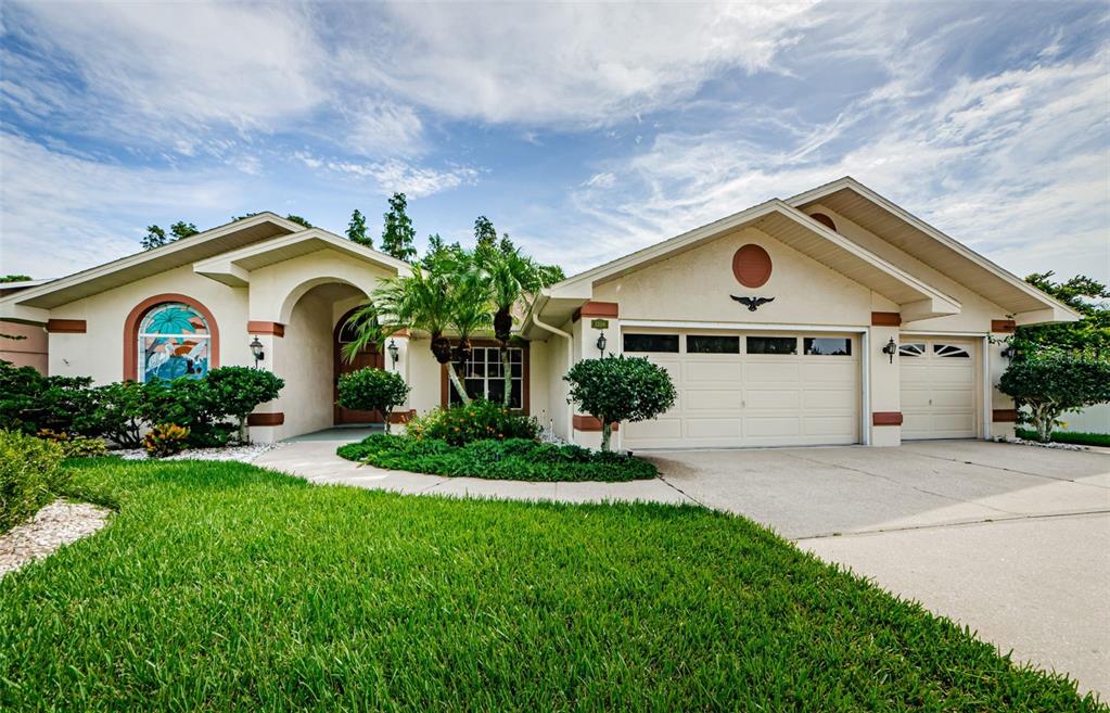 a front view of a house with a yard and garage