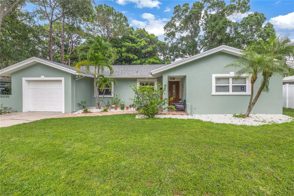 a front view of house with yard and green space