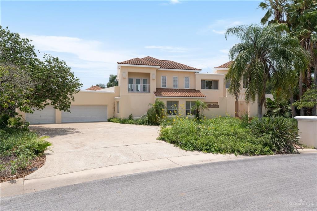 Mediterranean / spanish-style house with a garage