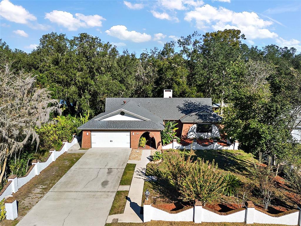 a aerial view of a house with a yard and sitting area