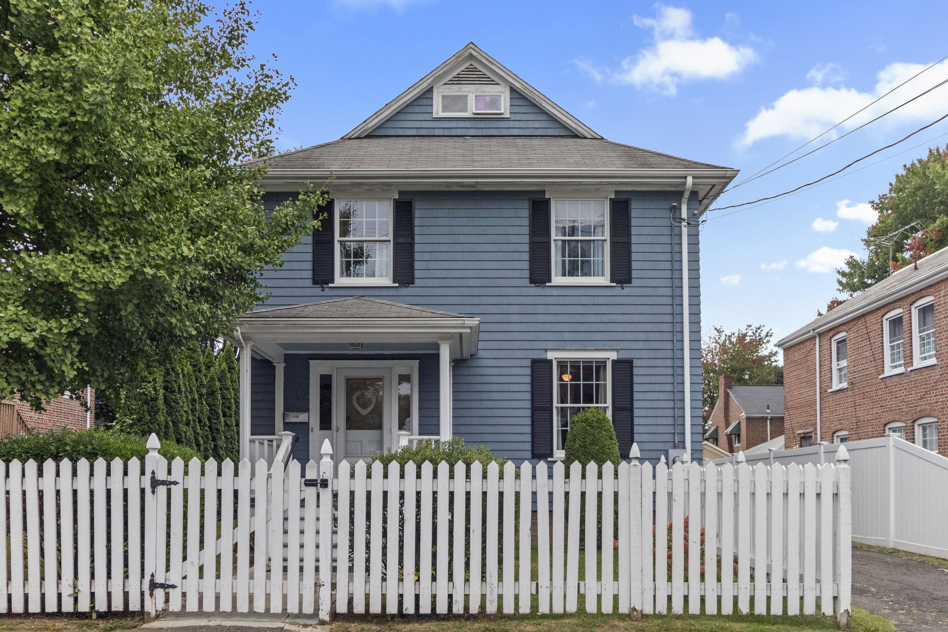 a front view of a house with a fence