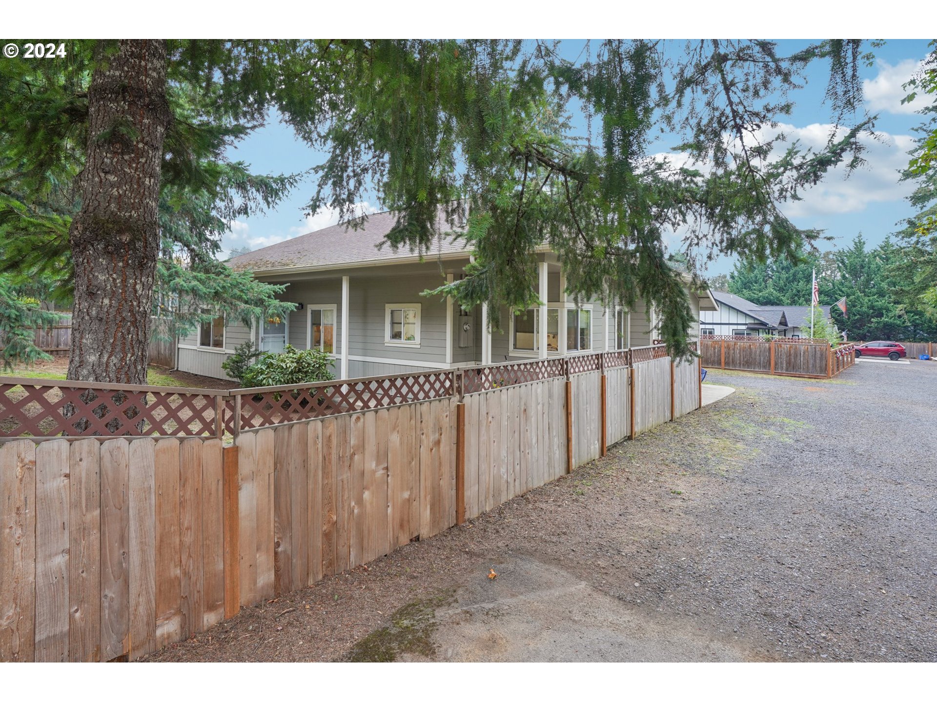 a view of a house with a wooden fence