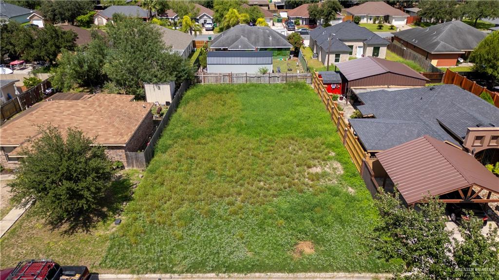 an aerial view of multiple houses with yard