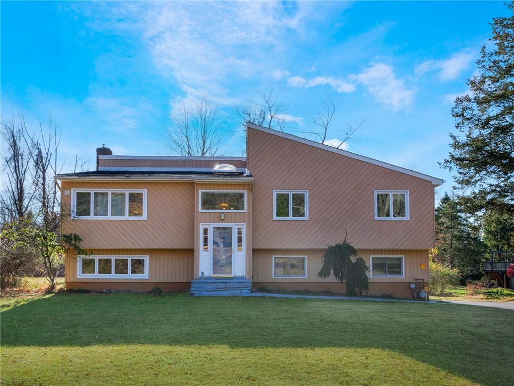 a front view of house with yard and green space