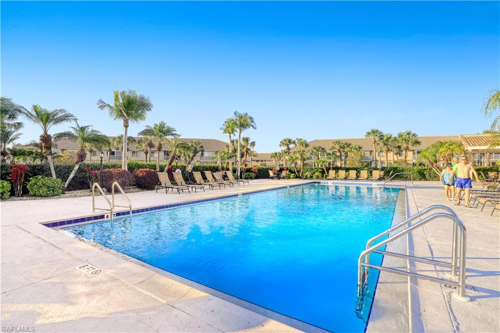 a view of a swimming pool with an outdoor seating