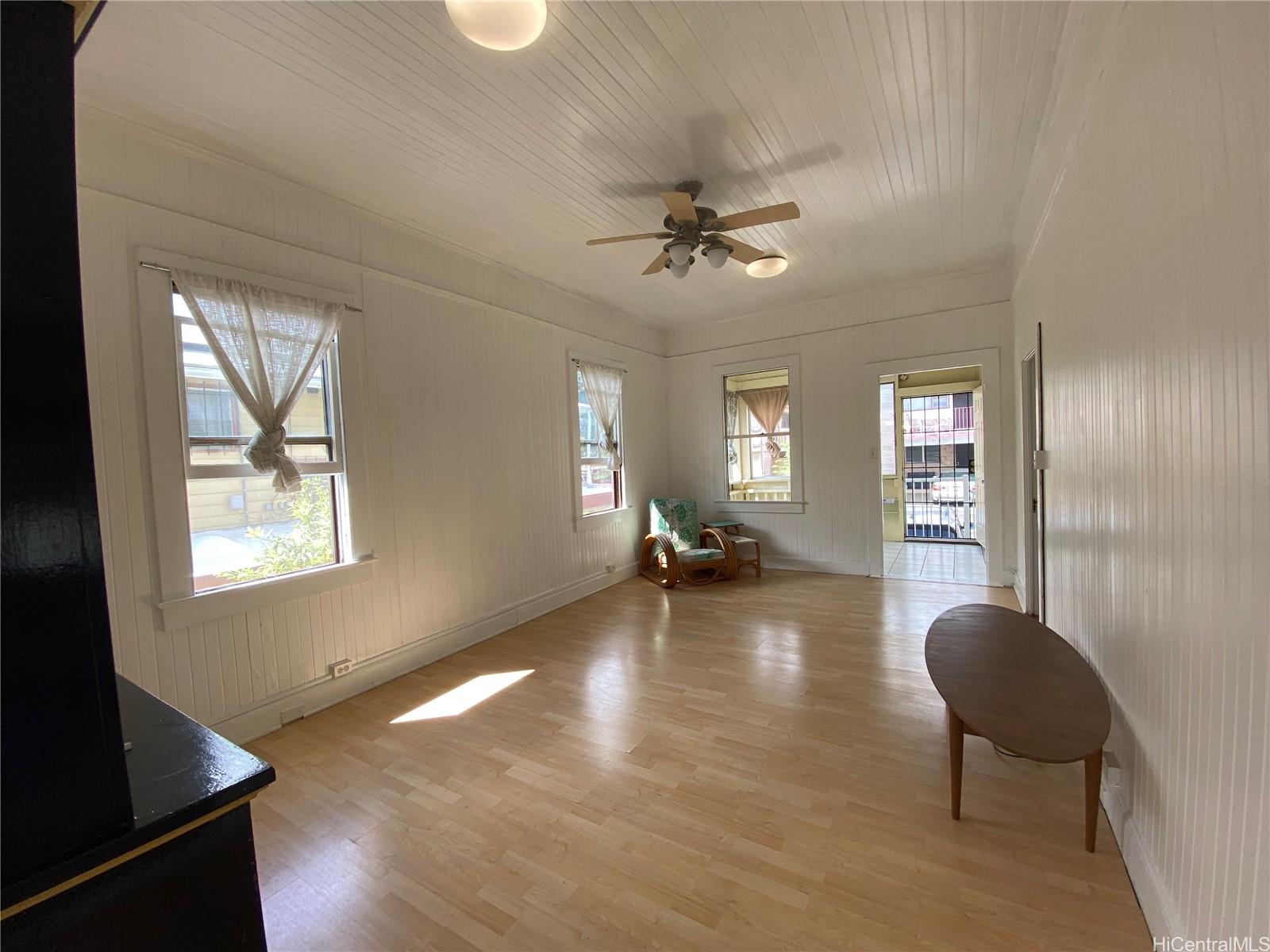 a view of living room with hardwood floor and windows