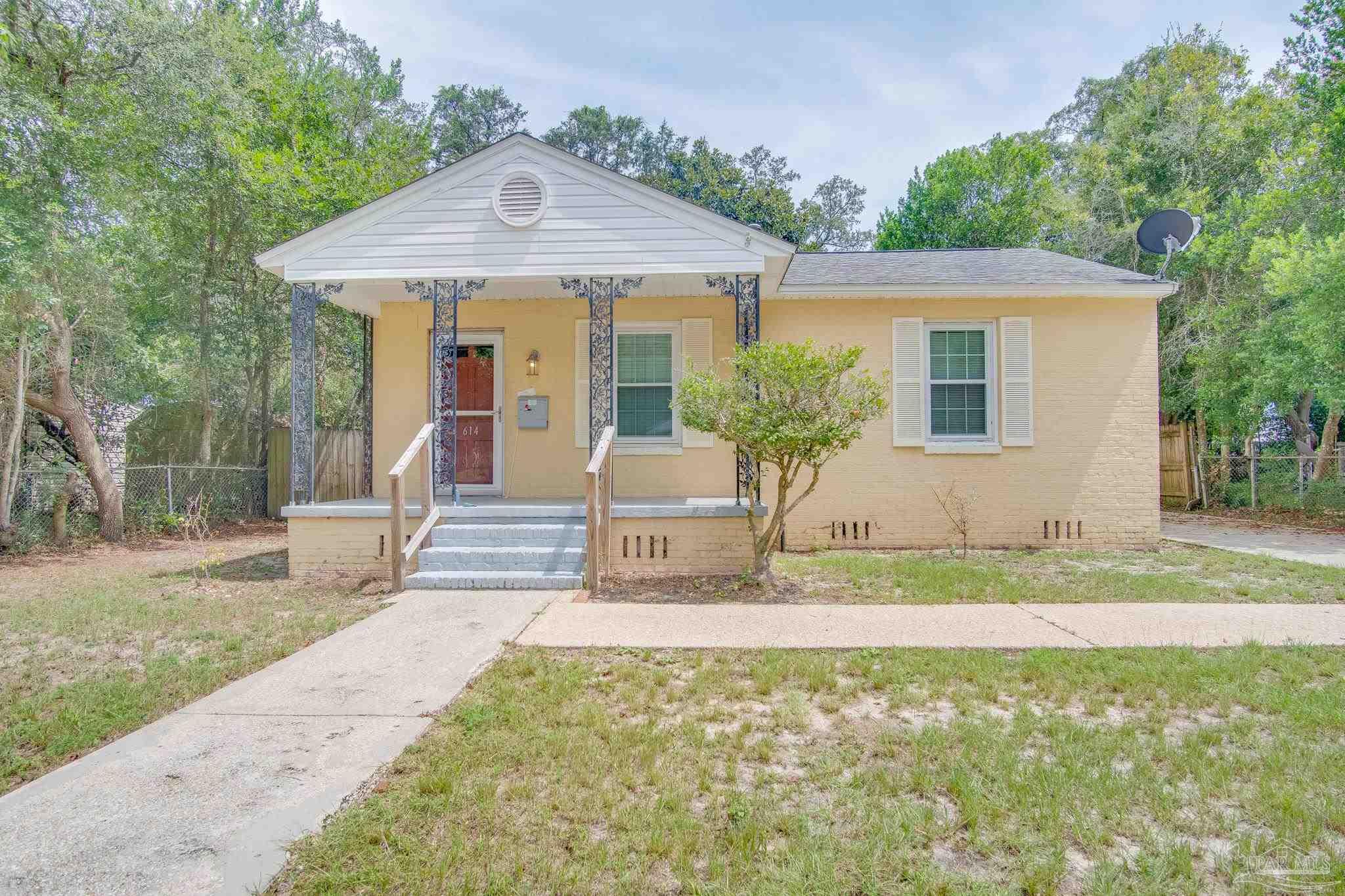 a front view of a house with a yard and porch