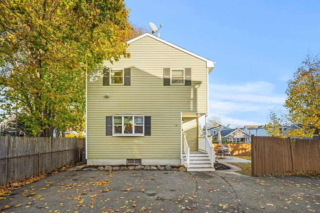 a front view of a house with a wooden fence