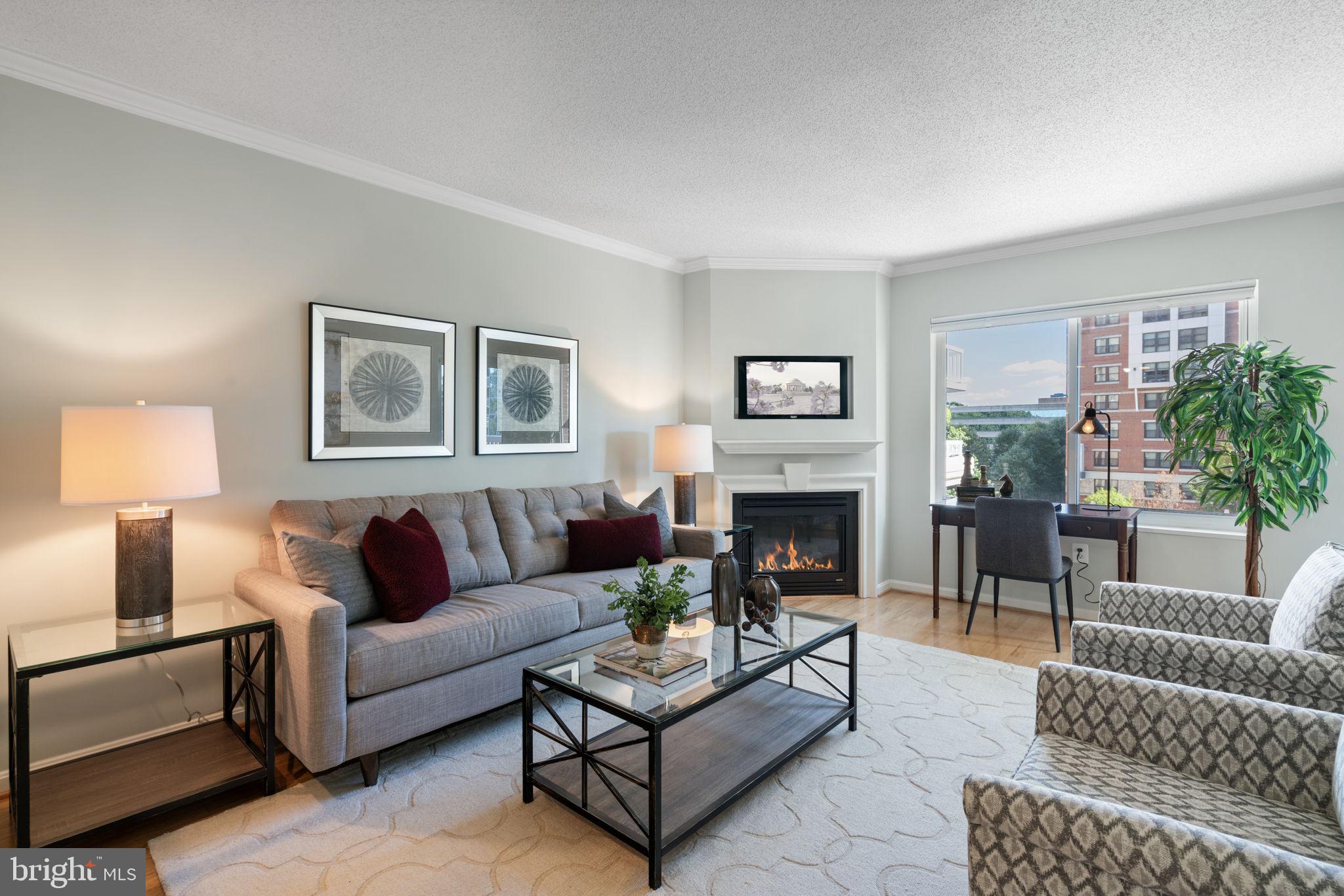 a living room with furniture a lamp and a fireplace