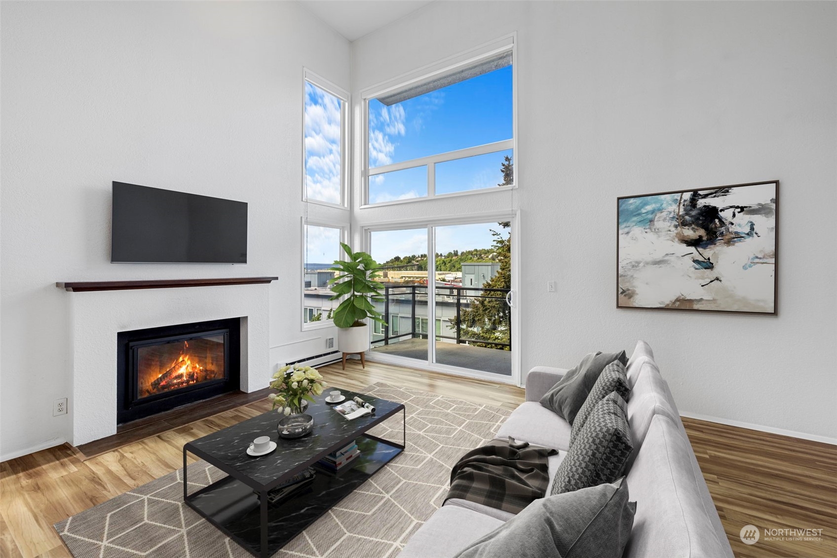 a living room with furniture a fireplace and a flat screen tv