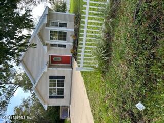 a front view of a house with a garden