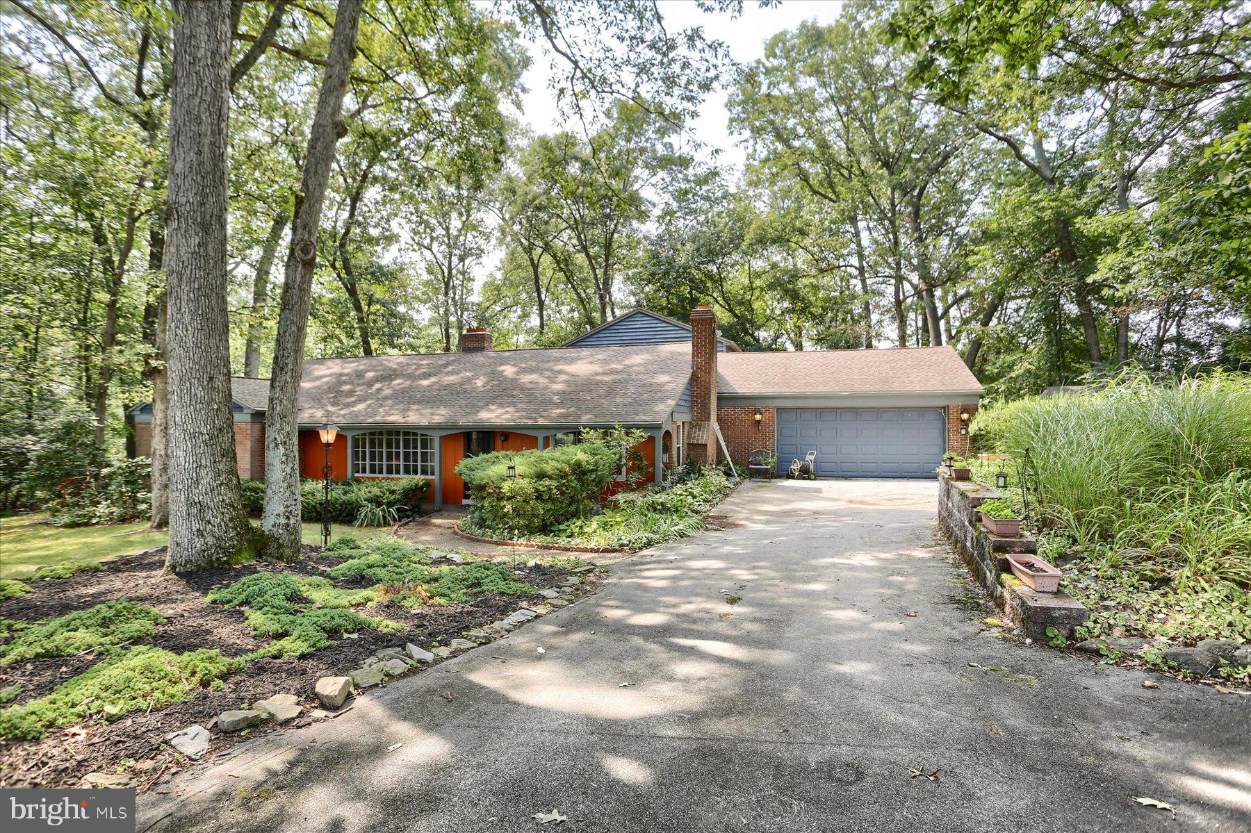 a front view of a house with a yard and a garage