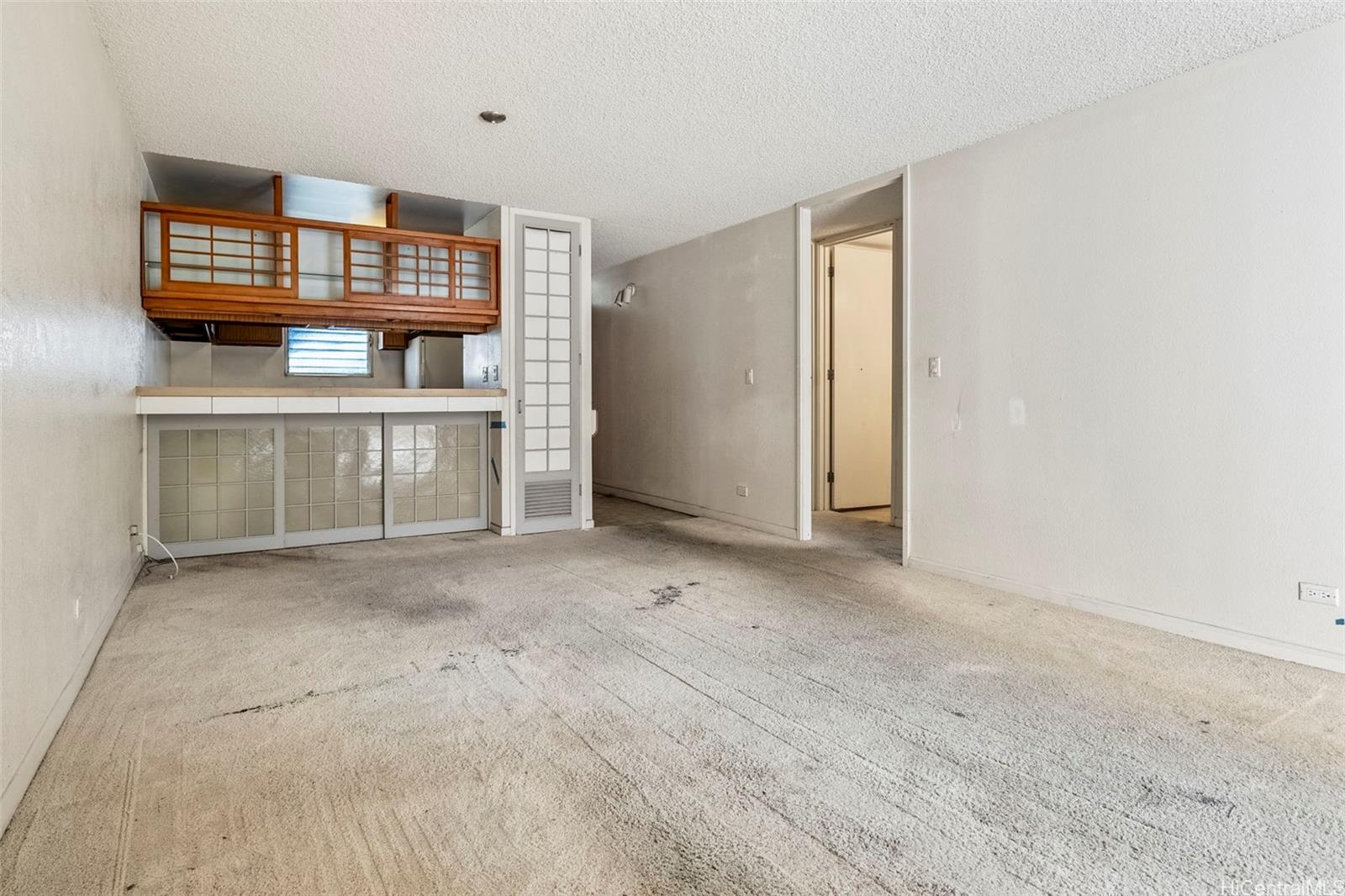 a view of a livingroom with furniture and natural light