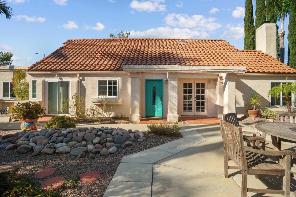 a view of a house with backyard and sitting area