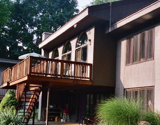 a front view of a house with plants and entryway