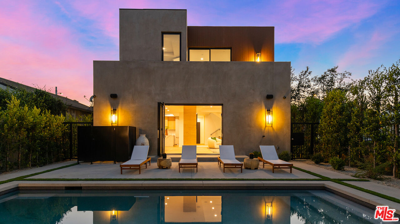 a view of a house with swimming pool and sitting area