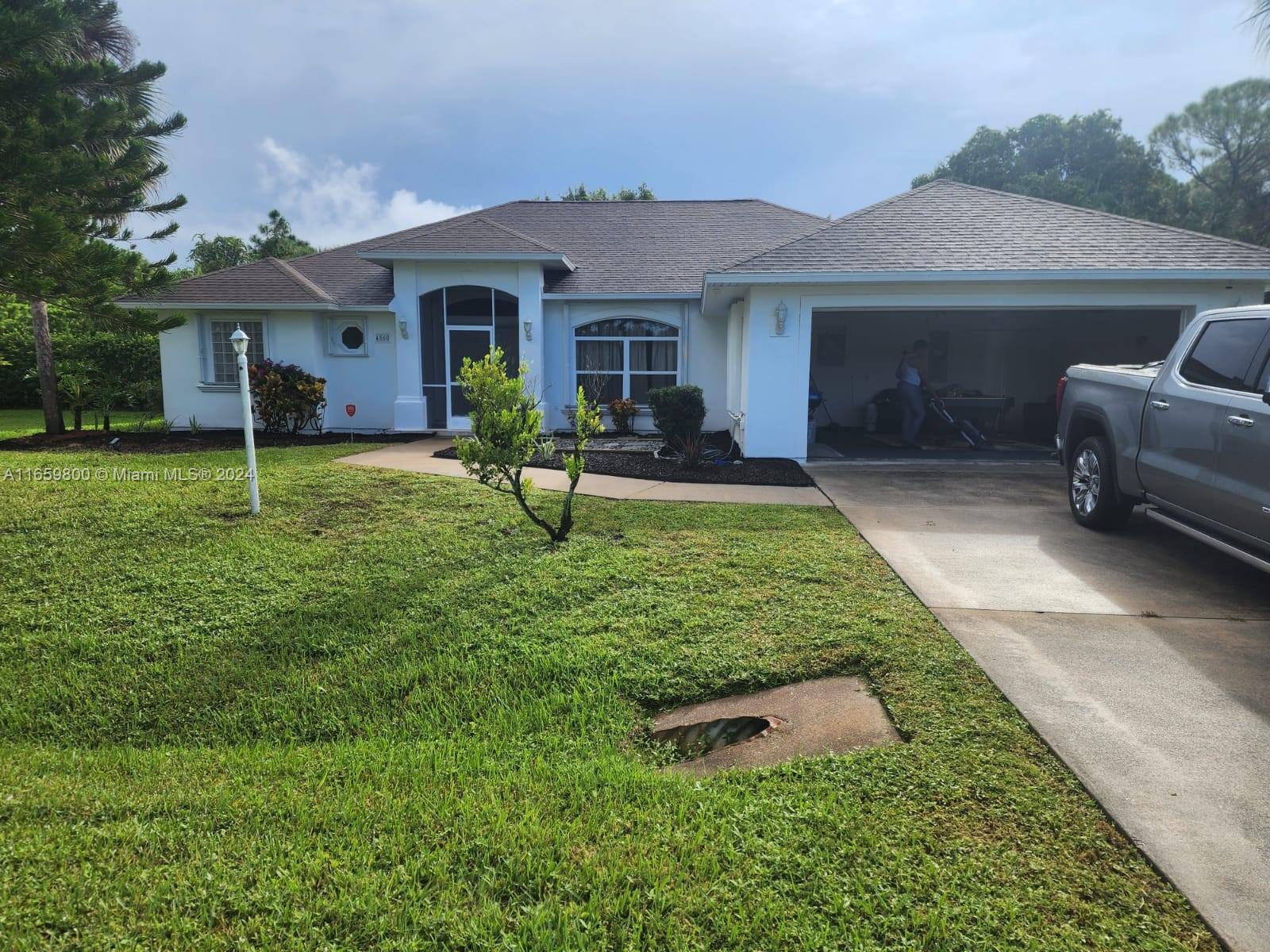 a front view of a house with a garden and porch