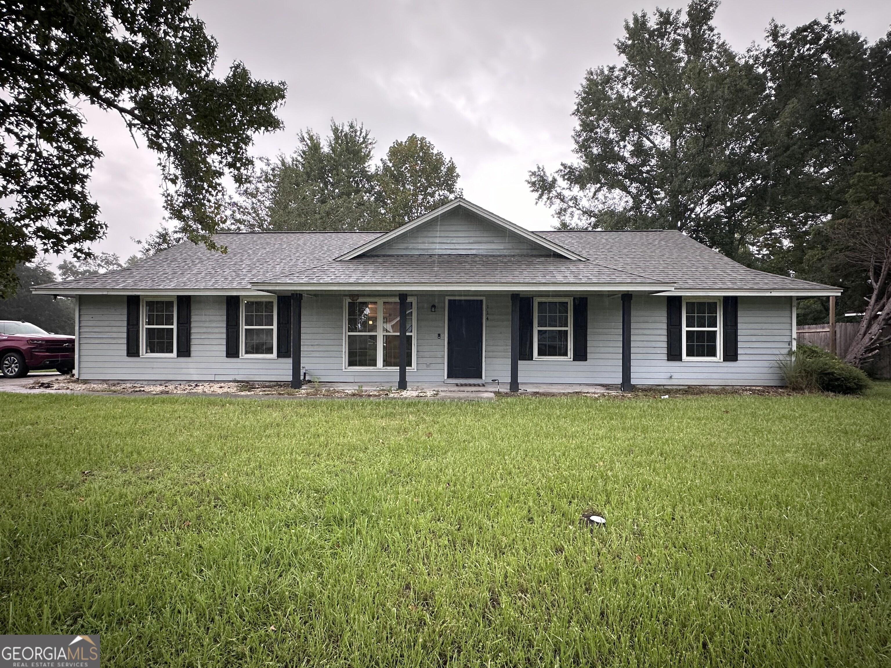 a front view of a house with a garden