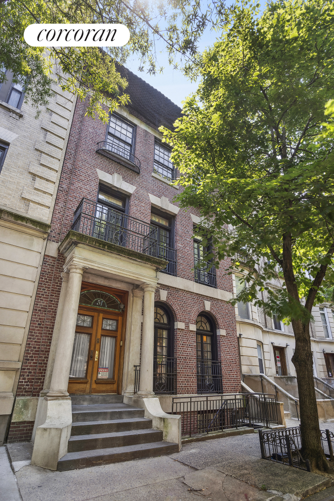 a view of a brick house with large windows