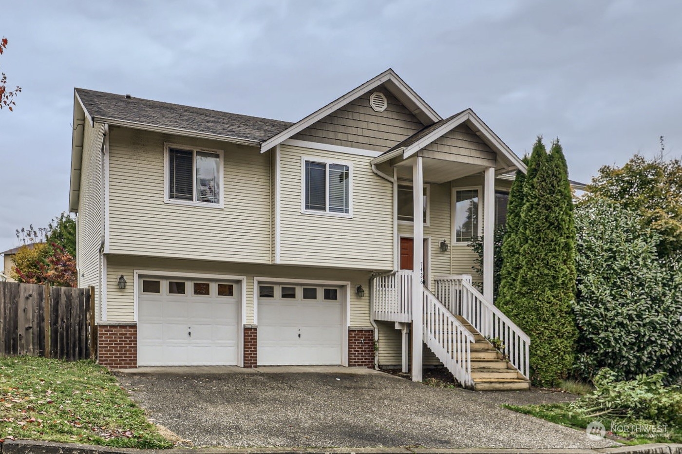 a view of a house with a yard and garage